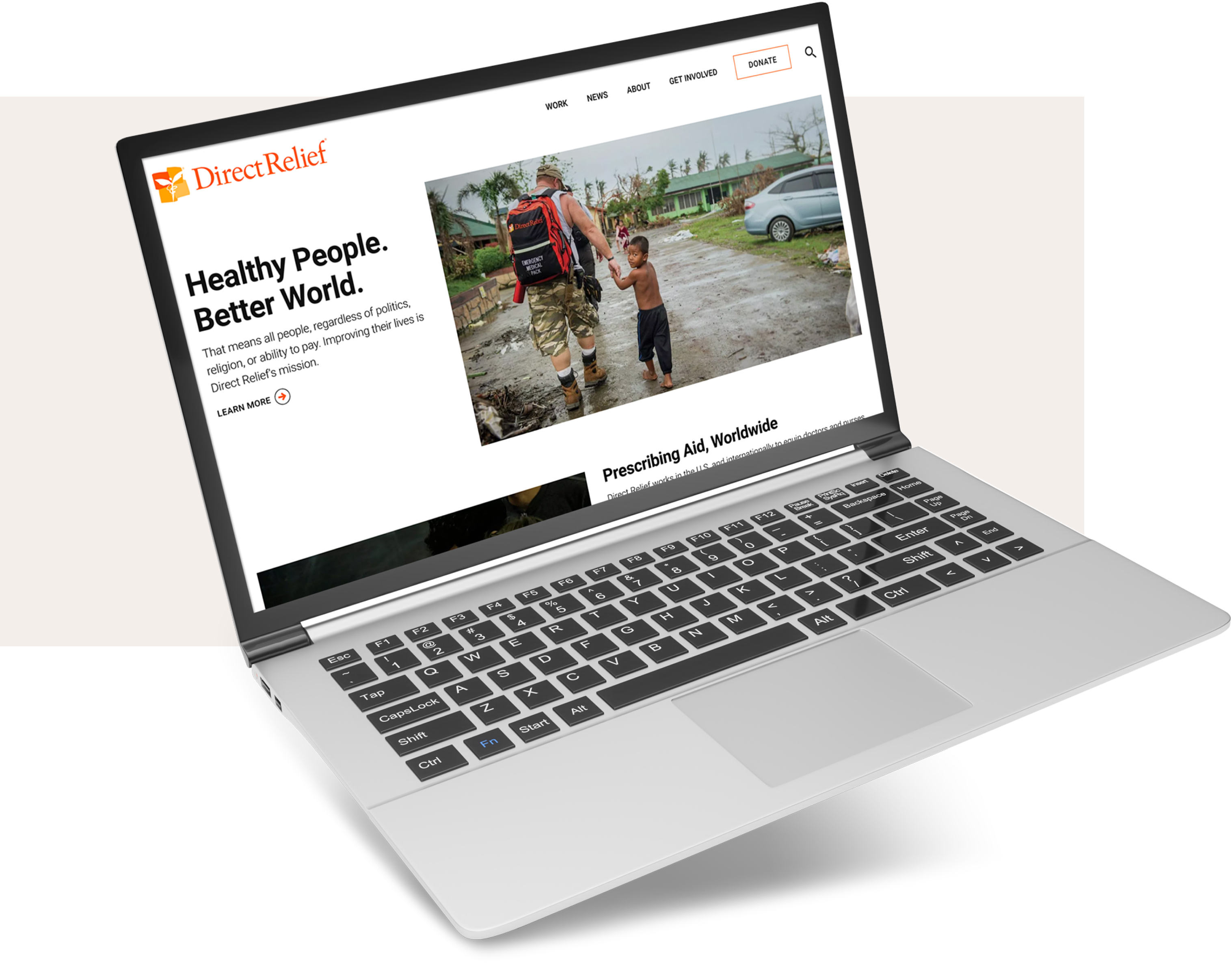 The Direct Relief homepage with a headline and image, displayed on a laptop screen